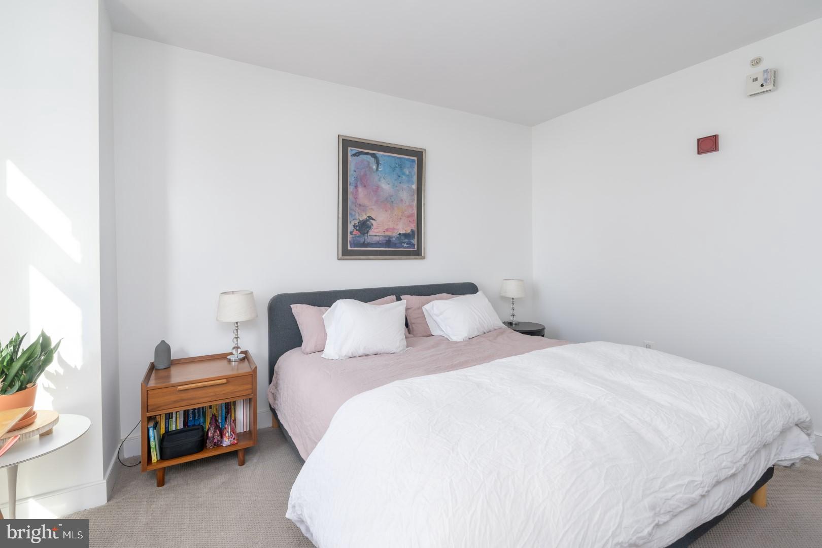 675 President Street, Unit 2402 Baltimore, MD 21202 - Photo 13 of 27 a bedroom with a bed and a couch