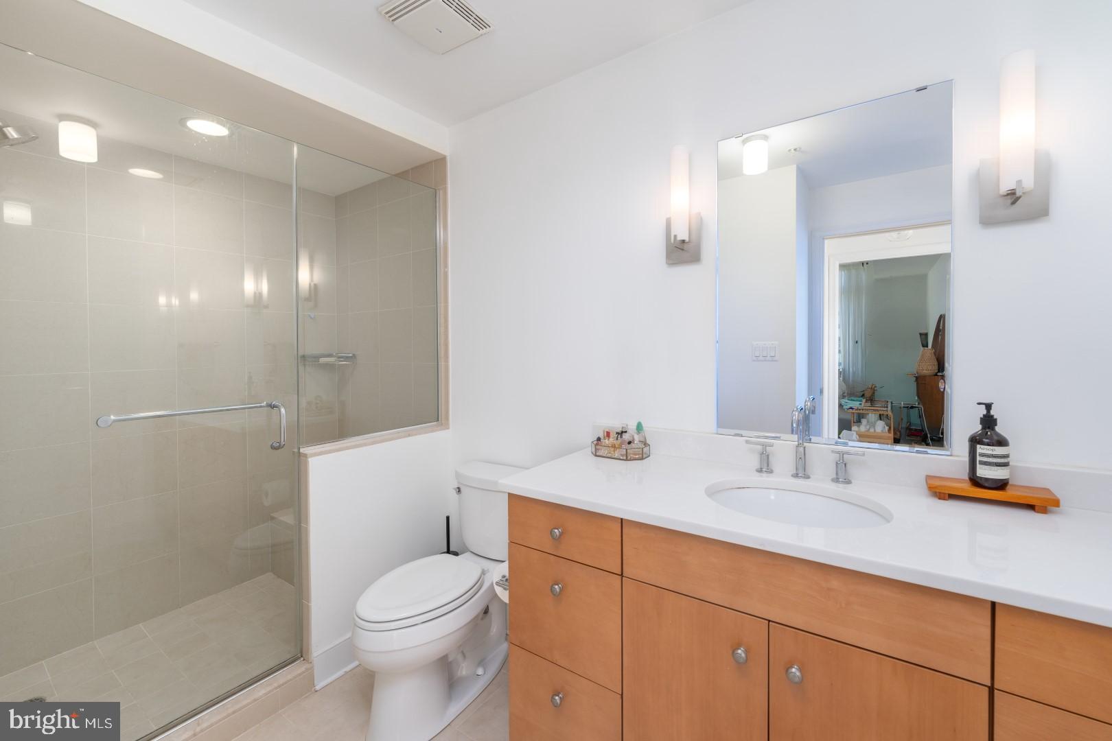 675 President Street, Unit 2402 Baltimore, MD 21202 - Photo 14 of 27 a bathroom with a sink a toilet and shower