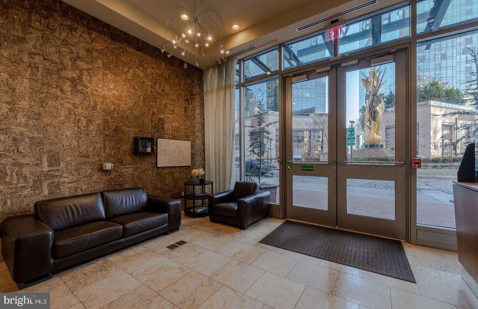 675 President Street, Unit 2402 Baltimore, MD 21202 - Photo 21 of 27 a living room with furniture and a flat screen tv