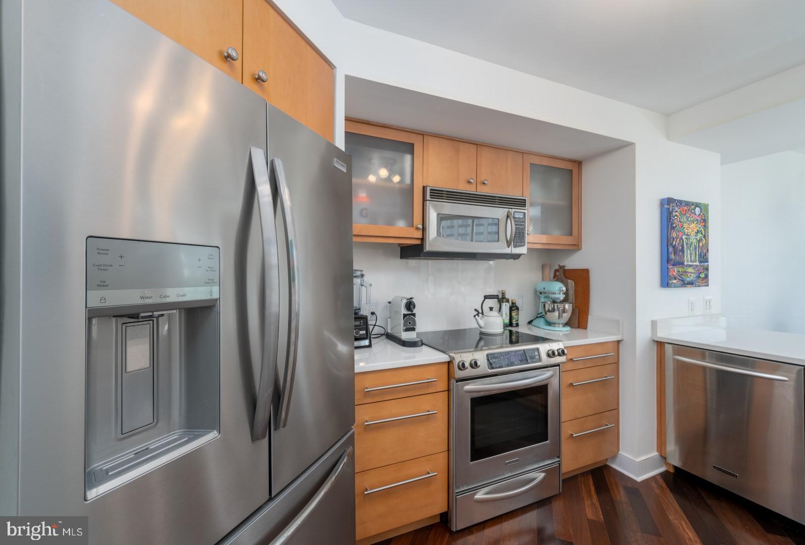 675 President Street, Unit 2402 Baltimore, MD 21202 - Photo 5 of 27 a kitchen with stainless steel appliances a refrigerator stove and sink