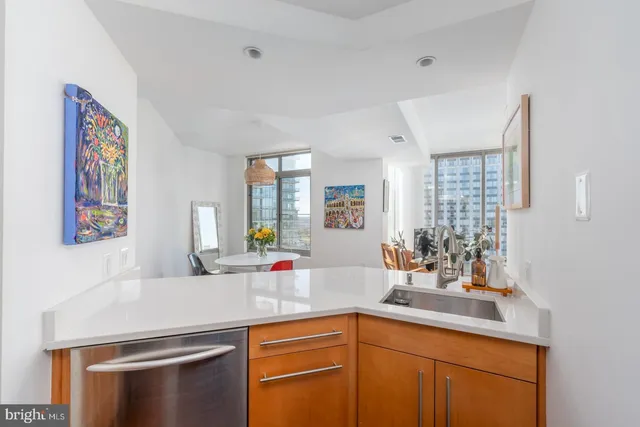 a kitchen with stainless steel appliances granite countertop a refrigerator and a microwave