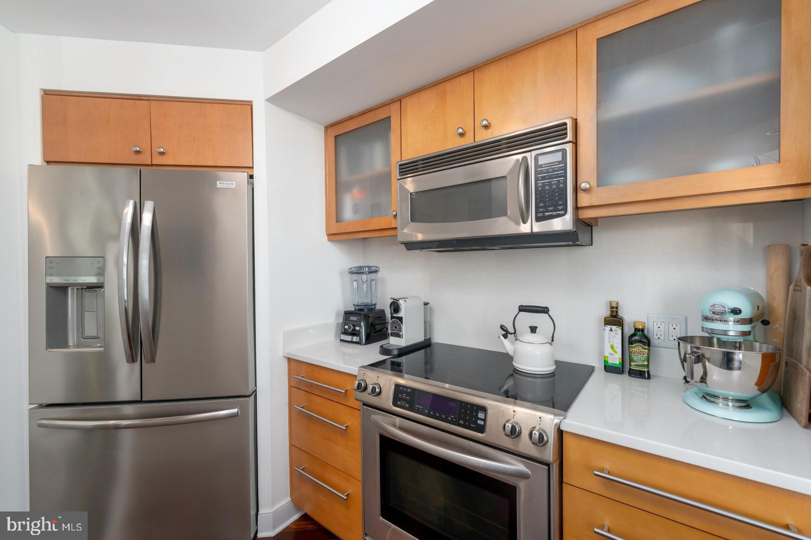 675 President Street, Unit 2402 Baltimore, MD 21202 - Photo 7 of 27 a kitchen with stainless steel appliances granite countertop a refrigerator and a microwave