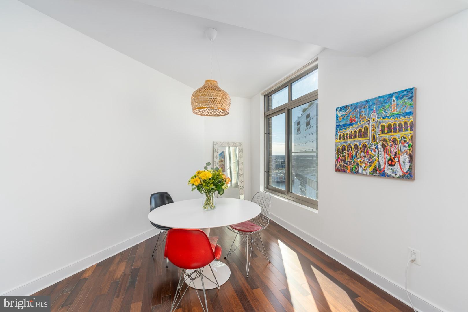 675 President Street, Unit 2402 Baltimore, MD 21202 - Photo 8 of 27 a view of a dining room with a table and chairs