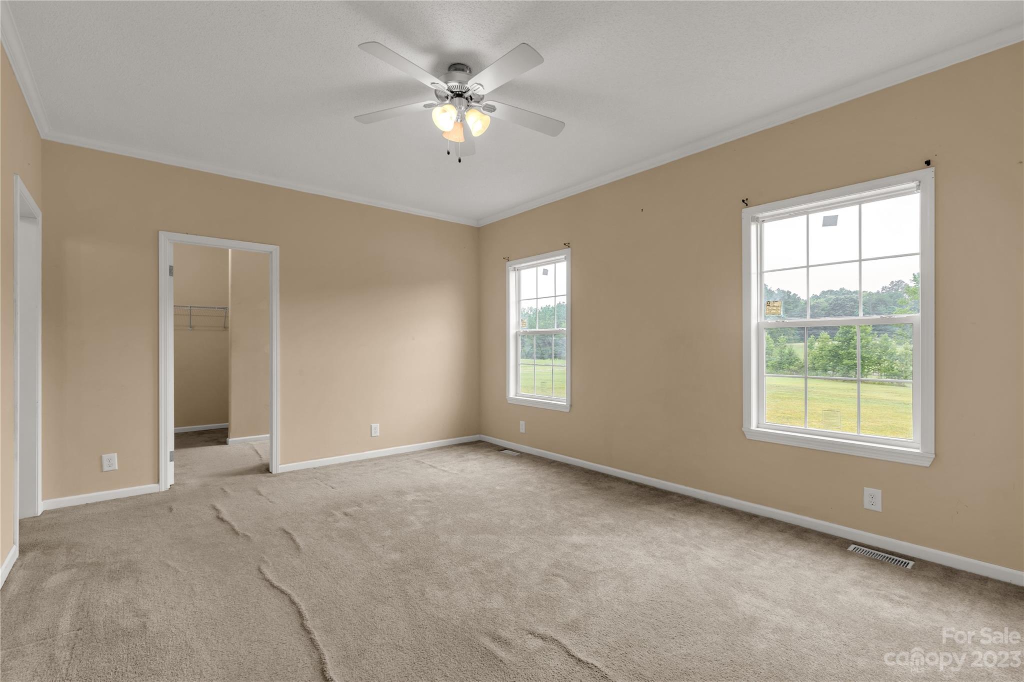 3052 Zeb Deese Road Lancaster, SC 29720 - Photo 23 of 34 an empty room with chandelier fan and windows
