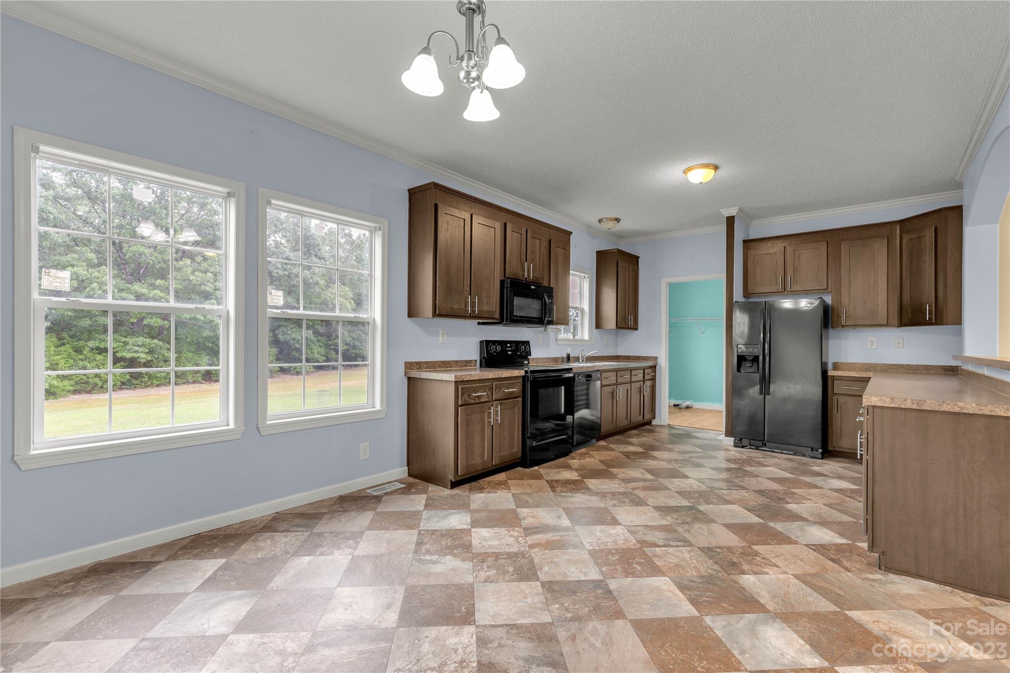 3052 Zeb Deese Road Lancaster, SC 29720 - Photo 7 of 34 a kitchen with stainless steel appliances granite countertop a refrigerator stove top oven and sink
