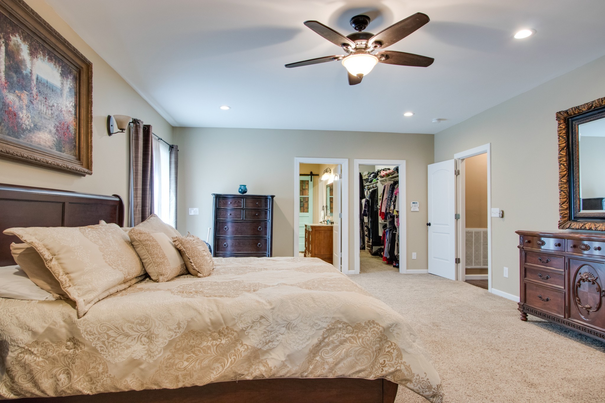 725 Fowler Ford Road Portland, TN 37148 - Photo 15 of 35 a bedroom with a large bed and a chandelier