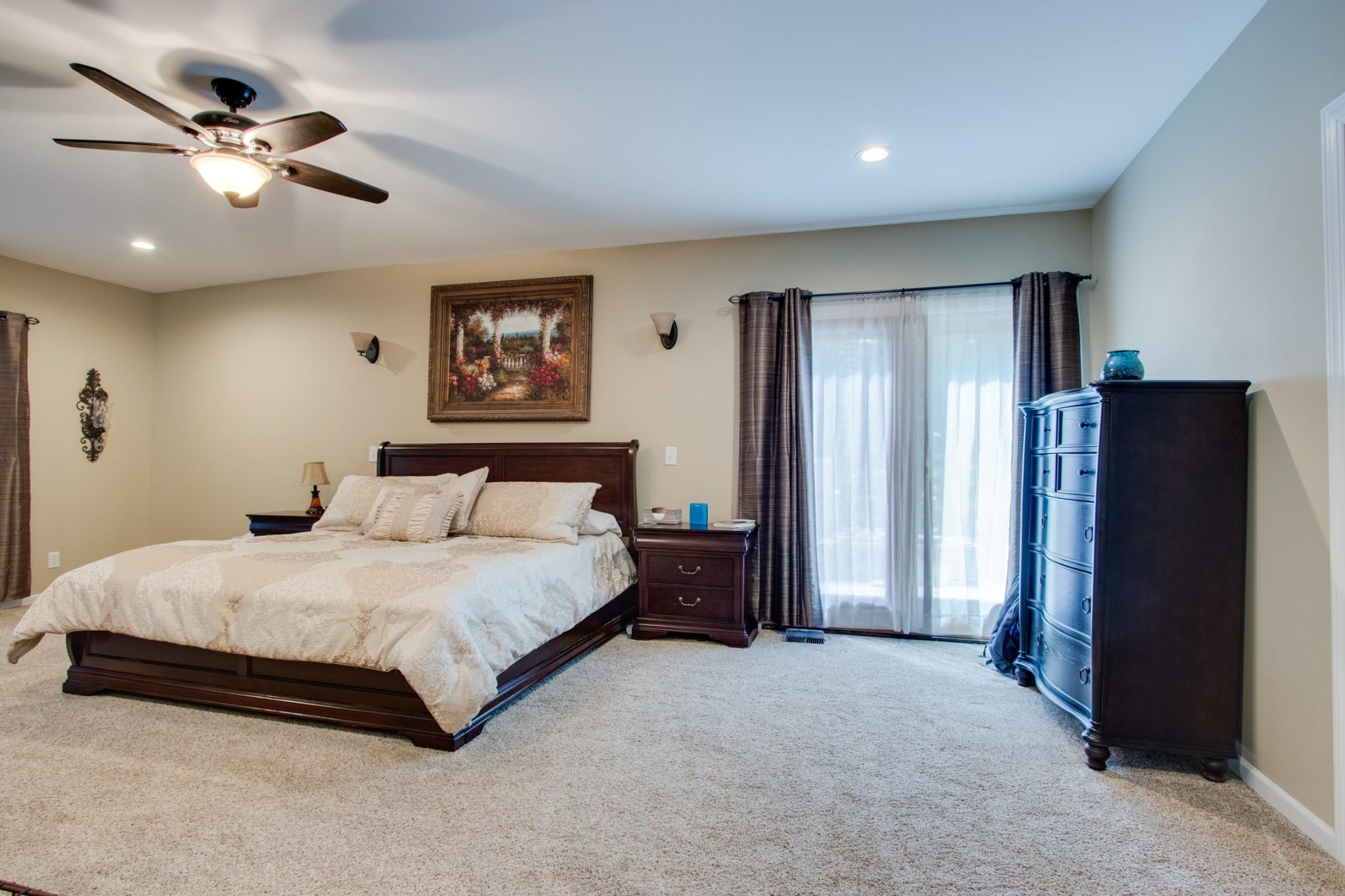 725 Fowler Ford Road Portland, TN 37148 - Photo 16 of 35 a spacious bedroom with a large bed and a chandelier