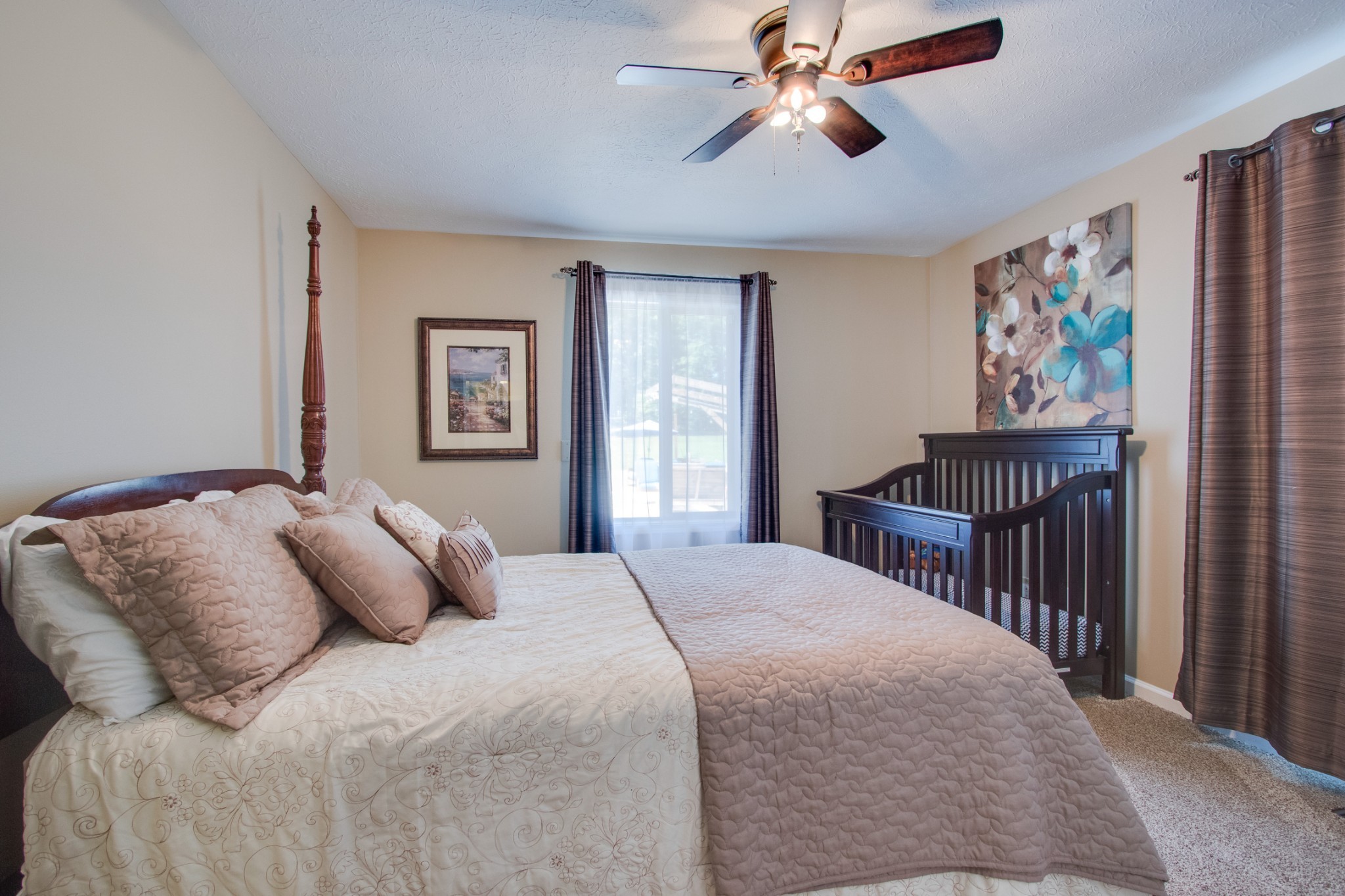 725 Fowler Ford Road Portland, TN 37148 - Photo 20 of 35 a bedroom with a bed and a chandelier