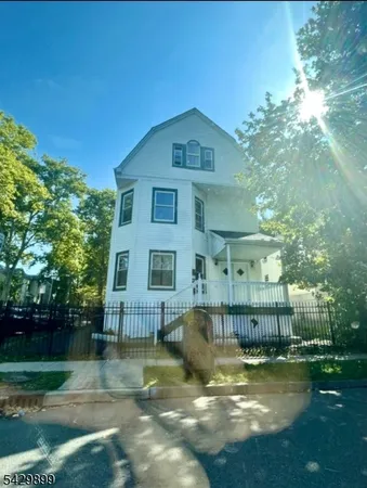 a view of backyard of house with green space