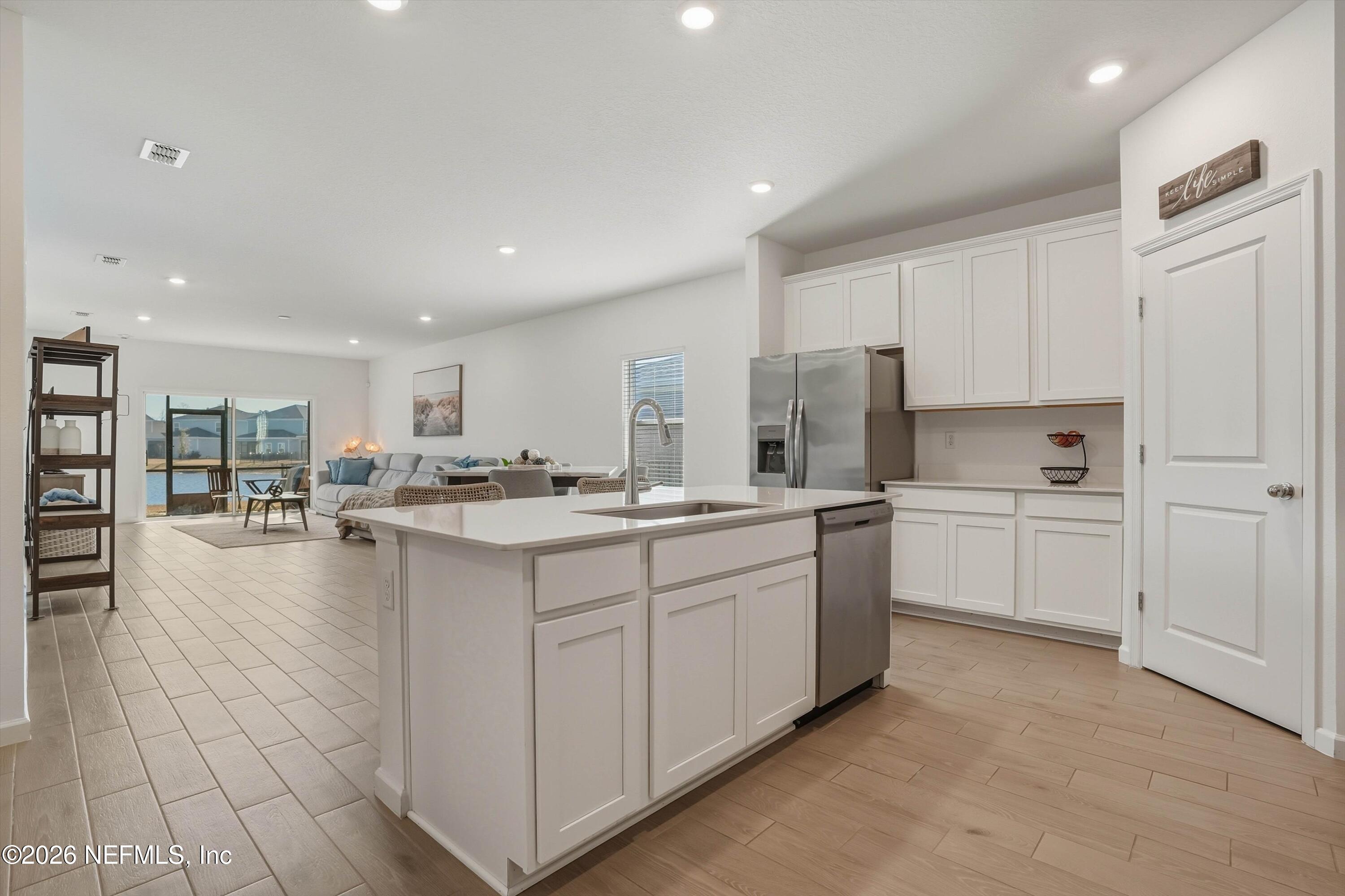 764 Lake Sinclair Street St. Augustine, FL 32084 - Photo 13 of 45 a kitchen with center island appliances and cabinets