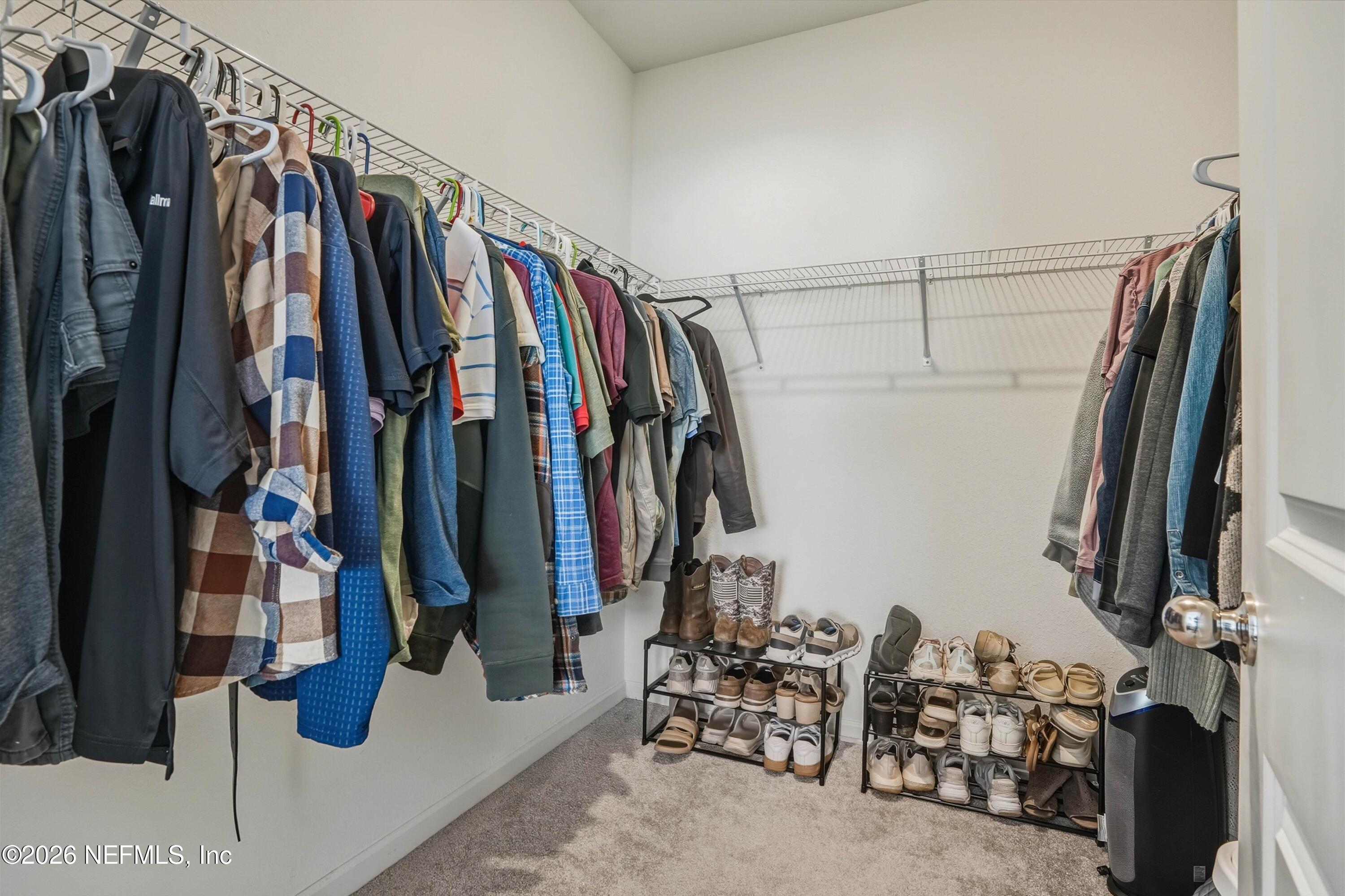764 Lake Sinclair Street St. Augustine, FL 32084 - Photo 21 of 45 a view of walk in closet with clothes and shoes