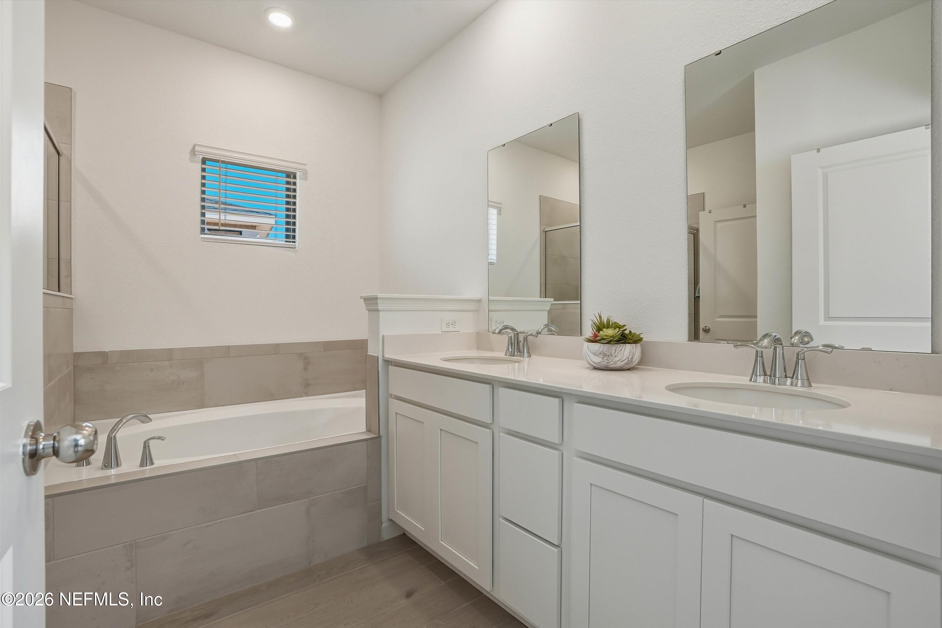 764 Lake Sinclair Street St. Augustine, FL 32084 - Photo 23 of 45 a bathroom with a tub sink and mirror
