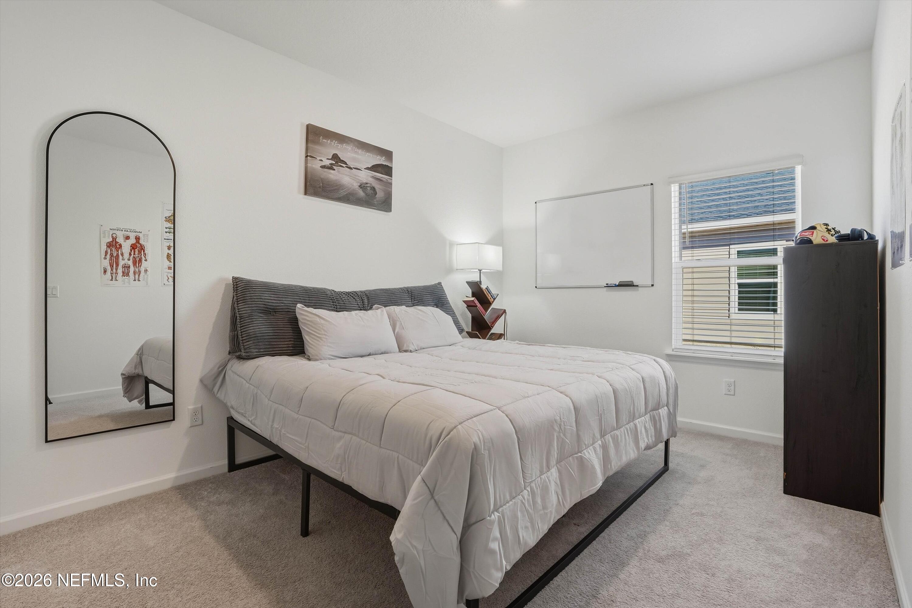 764 Lake Sinclair Street St. Augustine, FL 32084 - Photo 25 of 45 a bedroom with a bed and a window