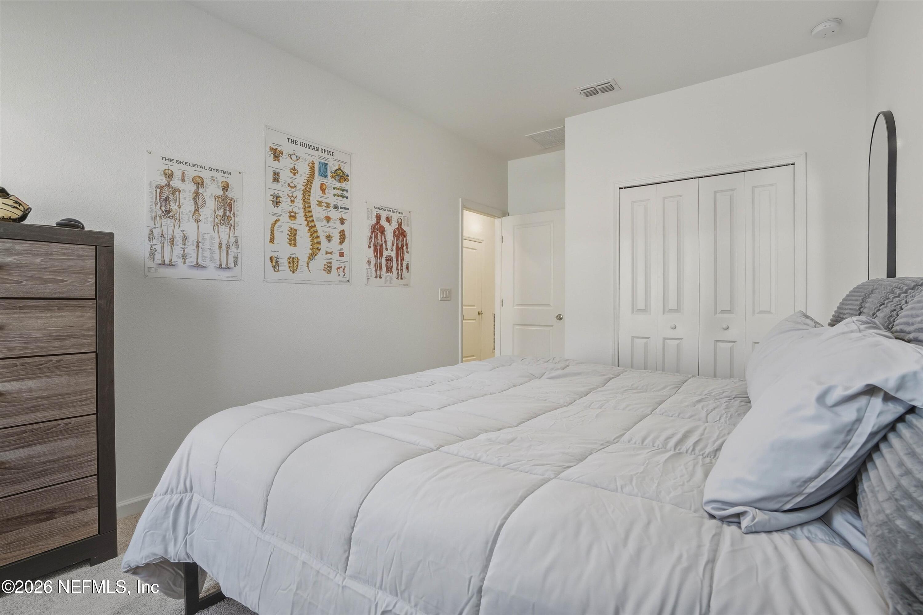 764 Lake Sinclair Street St. Augustine, FL 32084 - Photo 26 of 45 a bedroom with a bed and wall painting