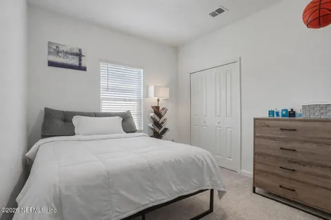 a bedroom with a bed and wall painting