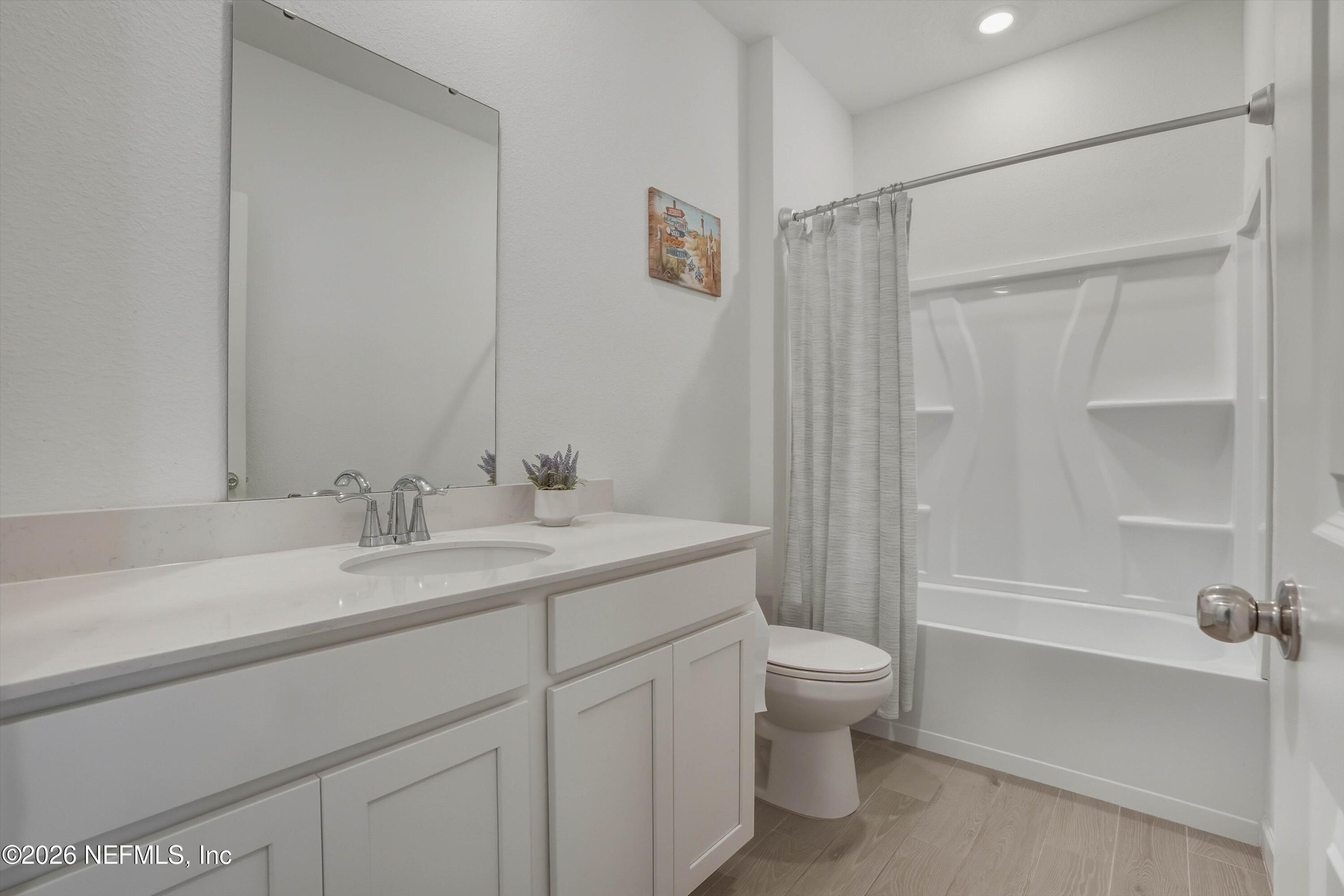 764 Lake Sinclair Street St. Augustine, FL 32084 - Photo 30 of 45 a bathroom with a sink a toilet and shower
