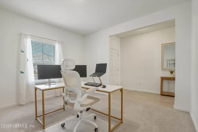 a view of a workspace with furniture