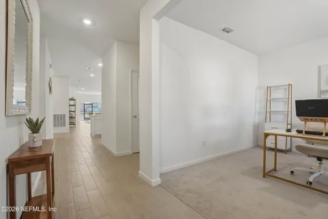 a view of a livingroom with furniture and a flat screen tv