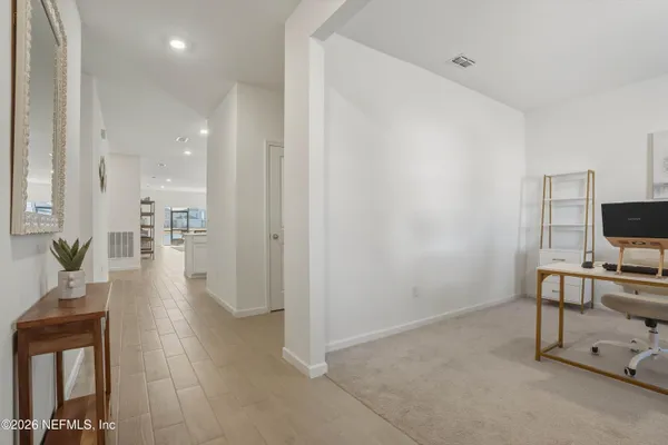 a view of a livingroom with furniture and a flat screen tv