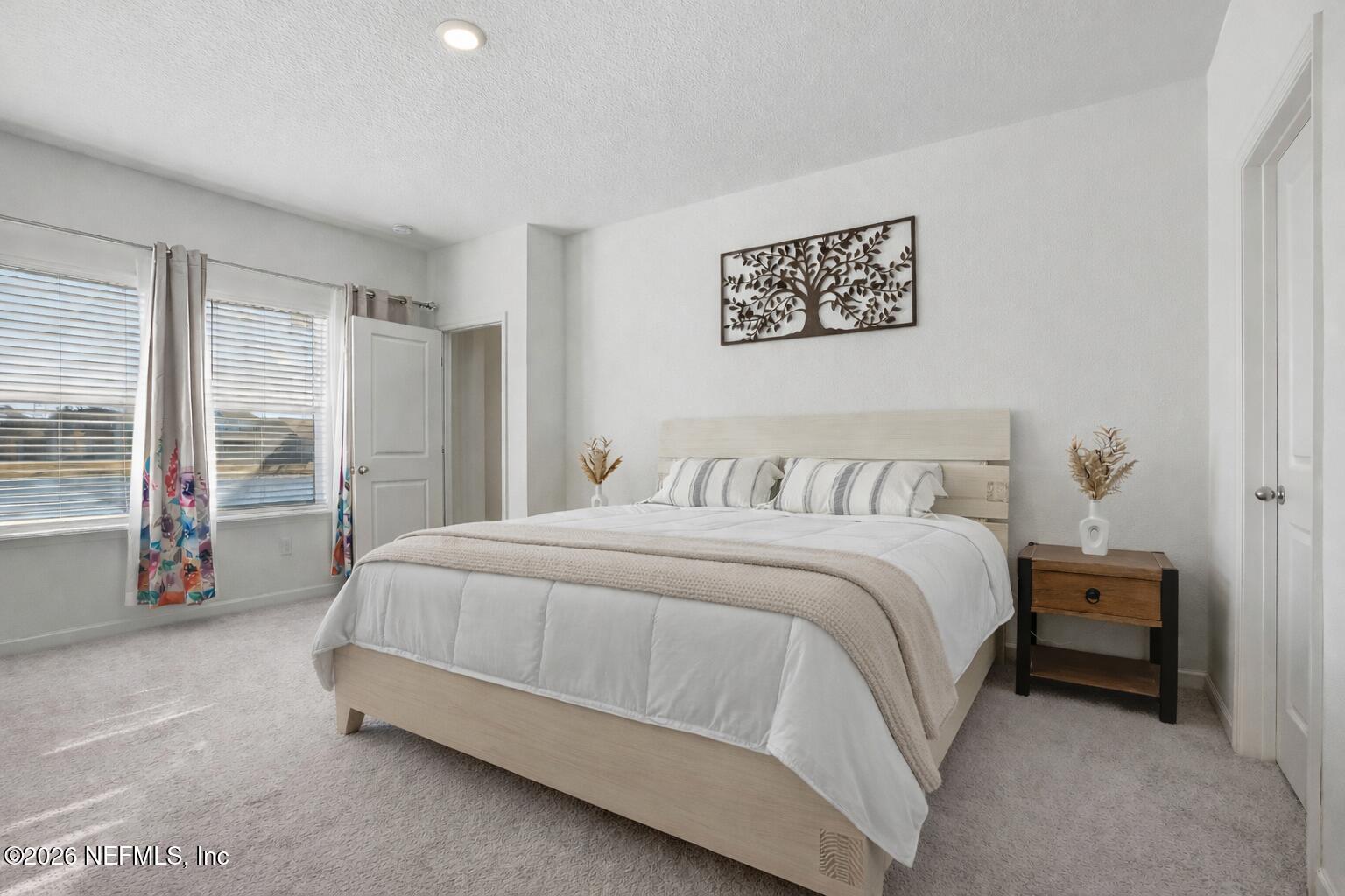 764 Lake Sinclair Street St. Augustine, FL 32084 - Photo 6 of 45 a spacious bedroom with a bed and a large window