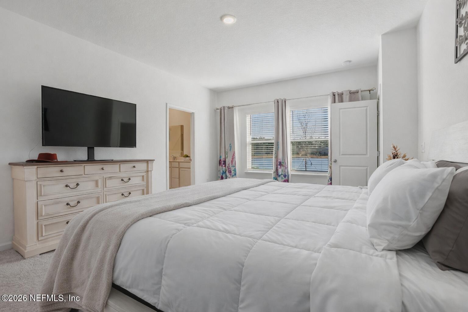 764 Lake Sinclair Street St. Augustine, FL 32084 - Photo 7 of 45 a bedroom with a bed and a flat screen tv