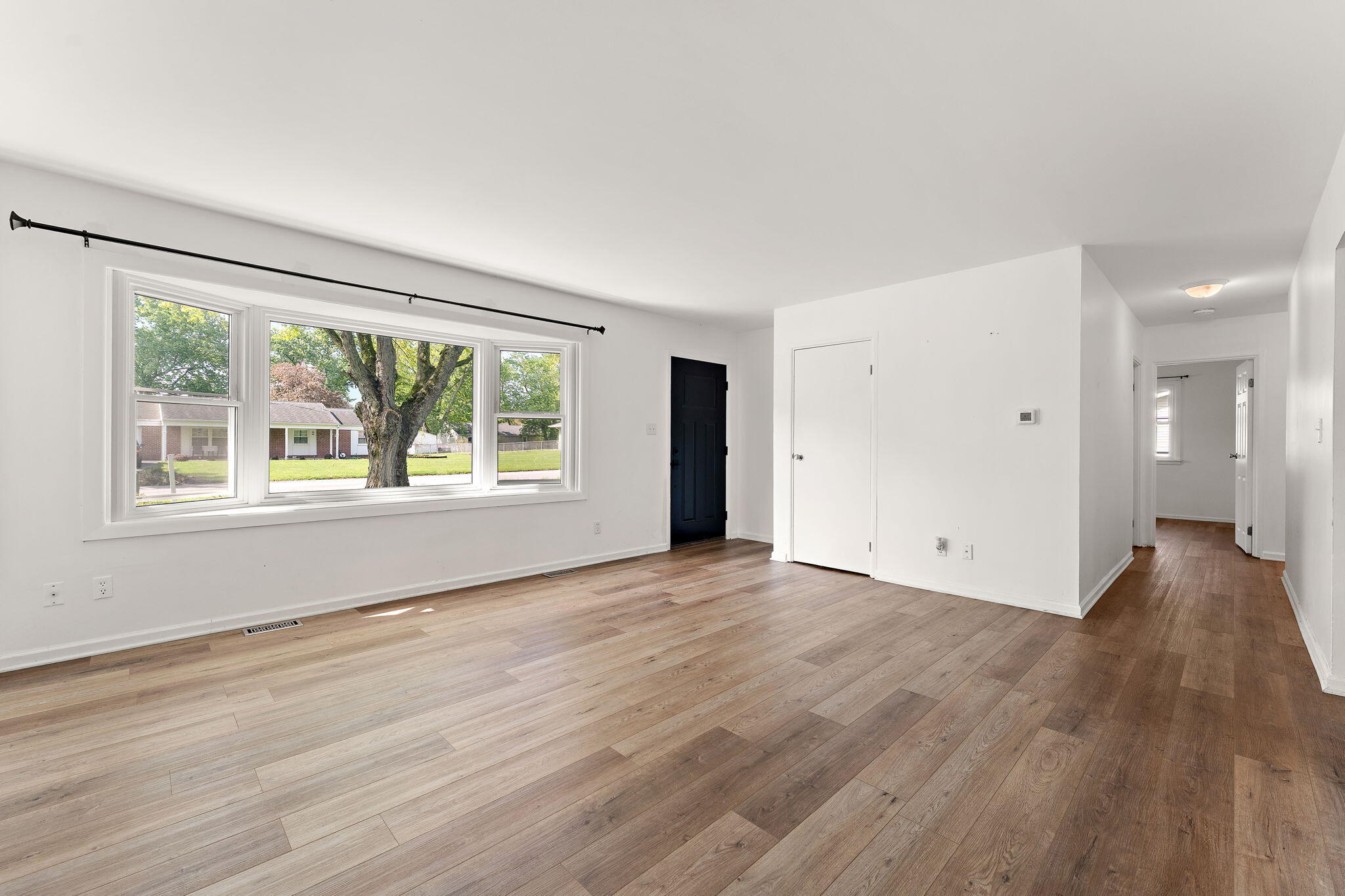 2201 Ade Avenue Valparaiso, IN 46383 - Photo 6 of 20 a view of an empty room with wooden floor and a window