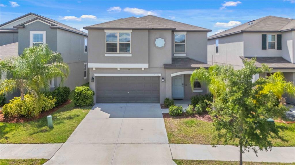 9440 Lemon Drop Loop Sun City Center, FL 33573 - Photo 1 of 55 a front view of a house with garden