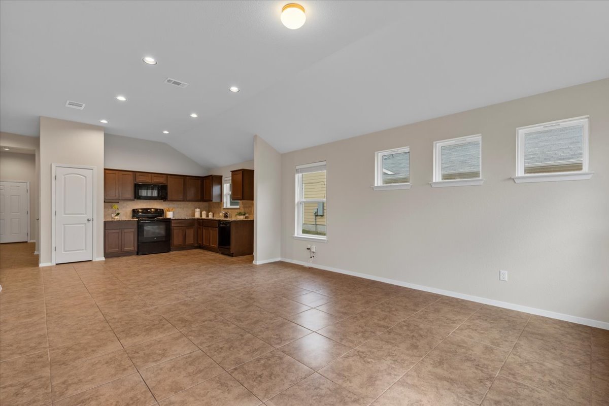 123 Saranac Drive Elgin, TX 78621 - Photo 7 of 27 The spacious living room features high ceilings and an open-concept layout.
