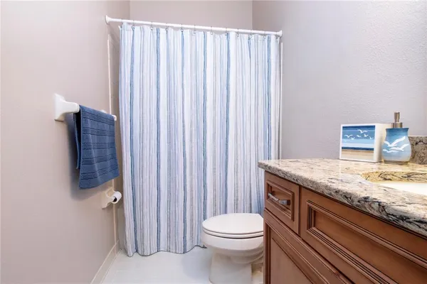 a bathroom with a sink mirror and vanity
