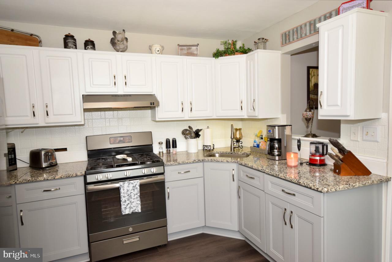 2419 Secane Road Secane, PA 19018 - Photo 12 of 46 a kitchen with granite countertop white cabinets and white appliances