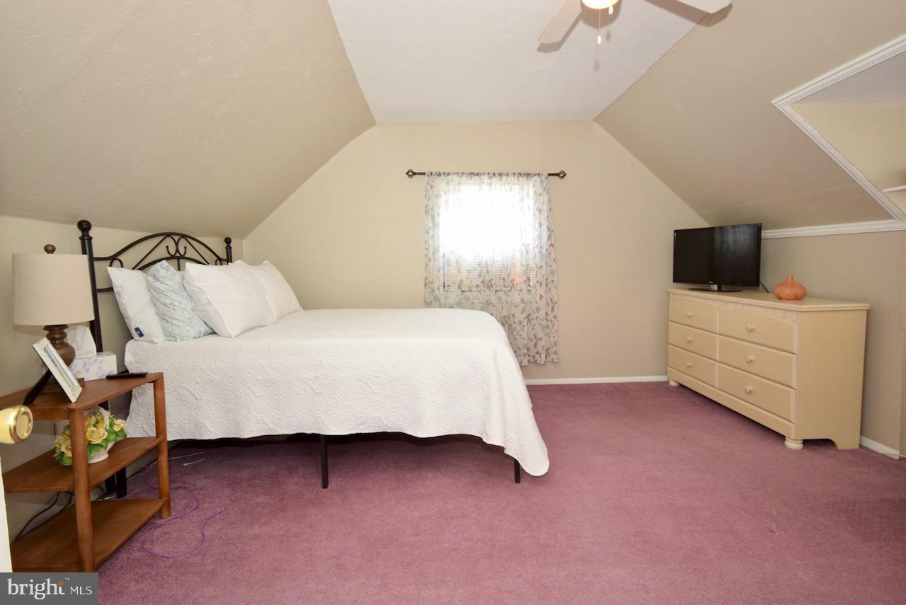 2419 Secane Road Secane, PA 19018 - Photo 35 of 46 a bedroom with a bed and a flat tv screen on the dresser