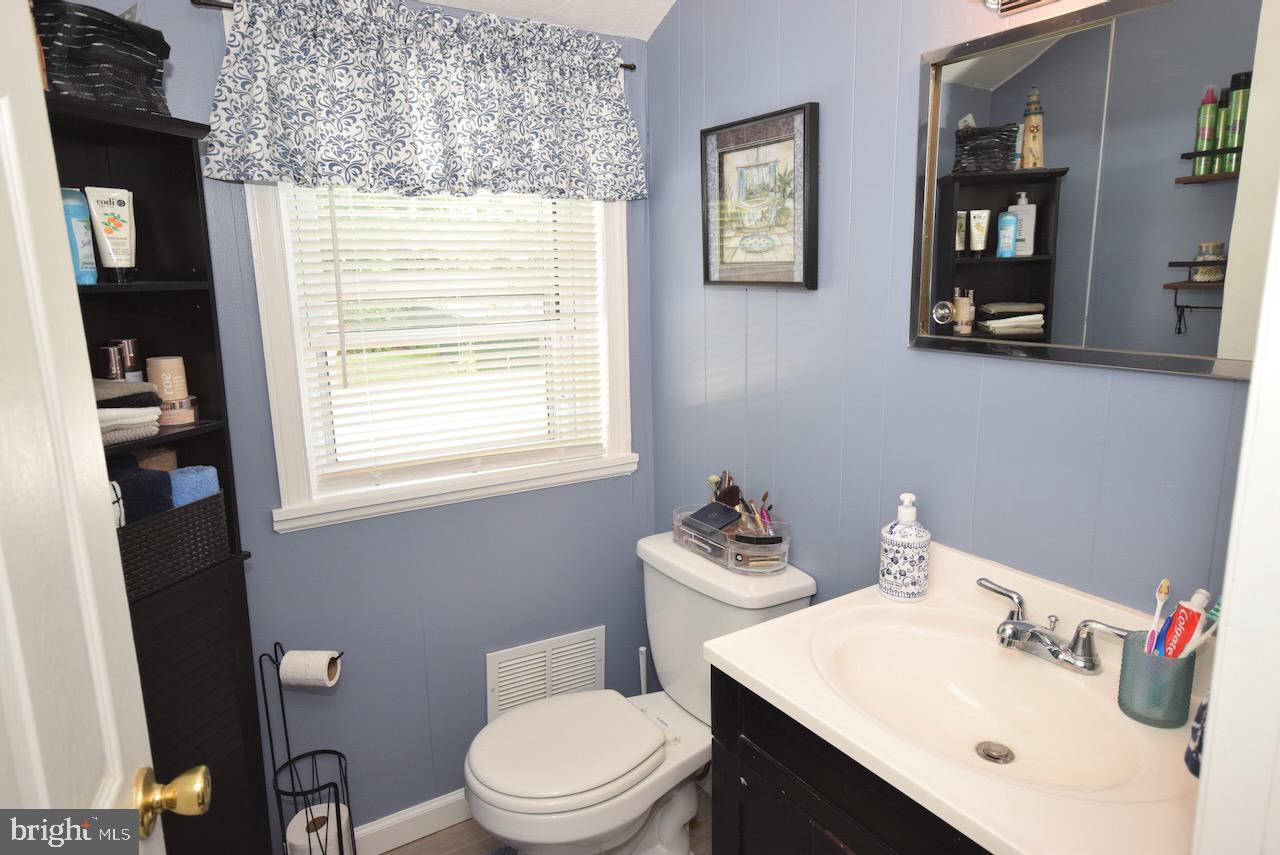 2419 Secane Road Secane, PA 19018 - Photo 38 of 46 a bathroom with a toilet a sink and a mirror
