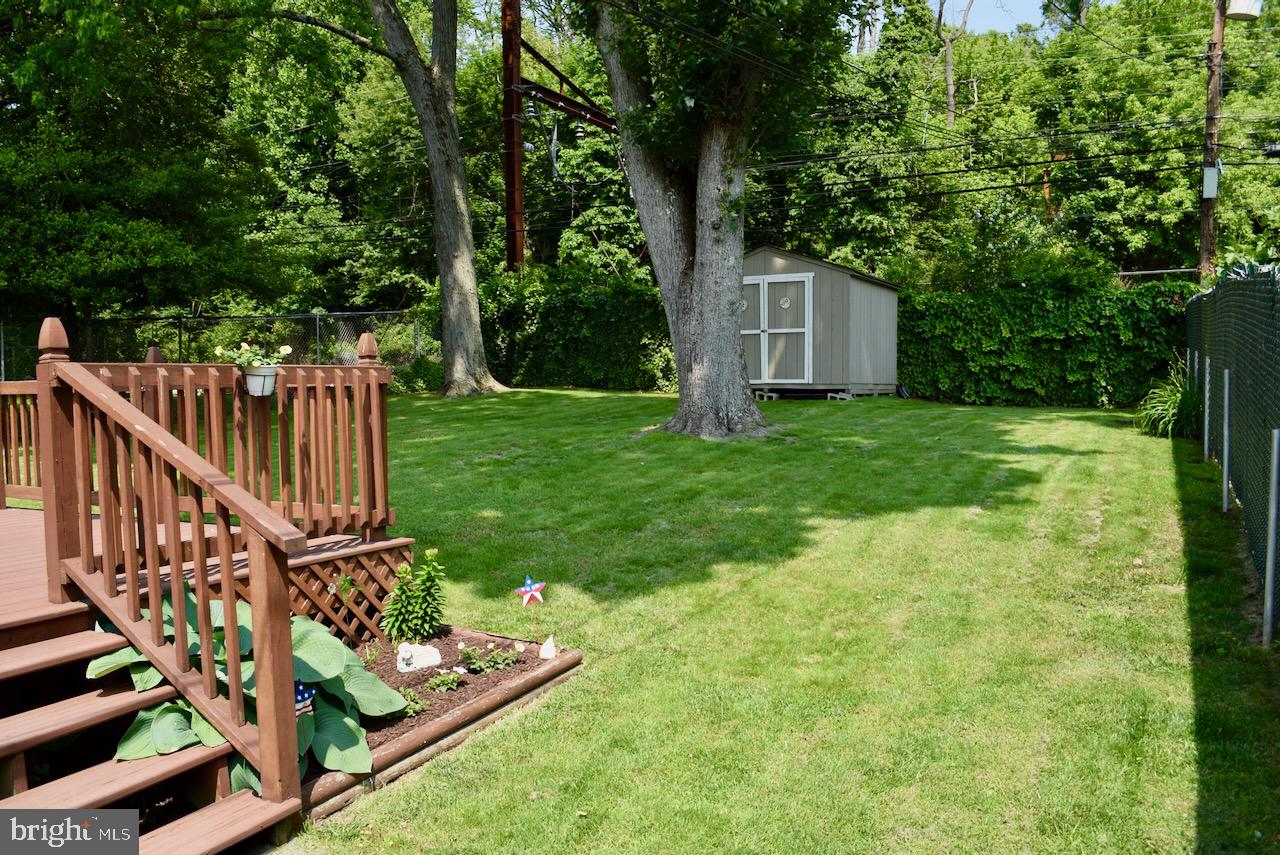 2419 Secane Road Secane, PA 19018 - Photo 41 of 46 a view of a backyard with wooden fence and large trees