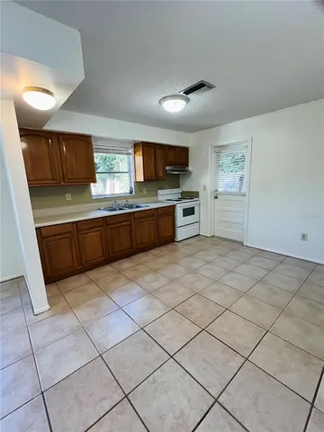 a large kitchen with a stove a sink dishwasher and a refrigerator