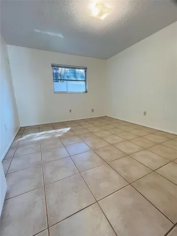 a view of a room with a white cabinets and wooden floor