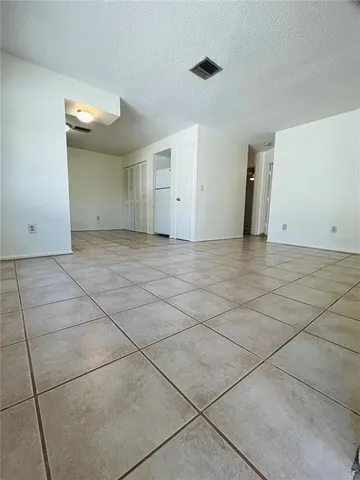 a view of a livingroom with an empty space and a window