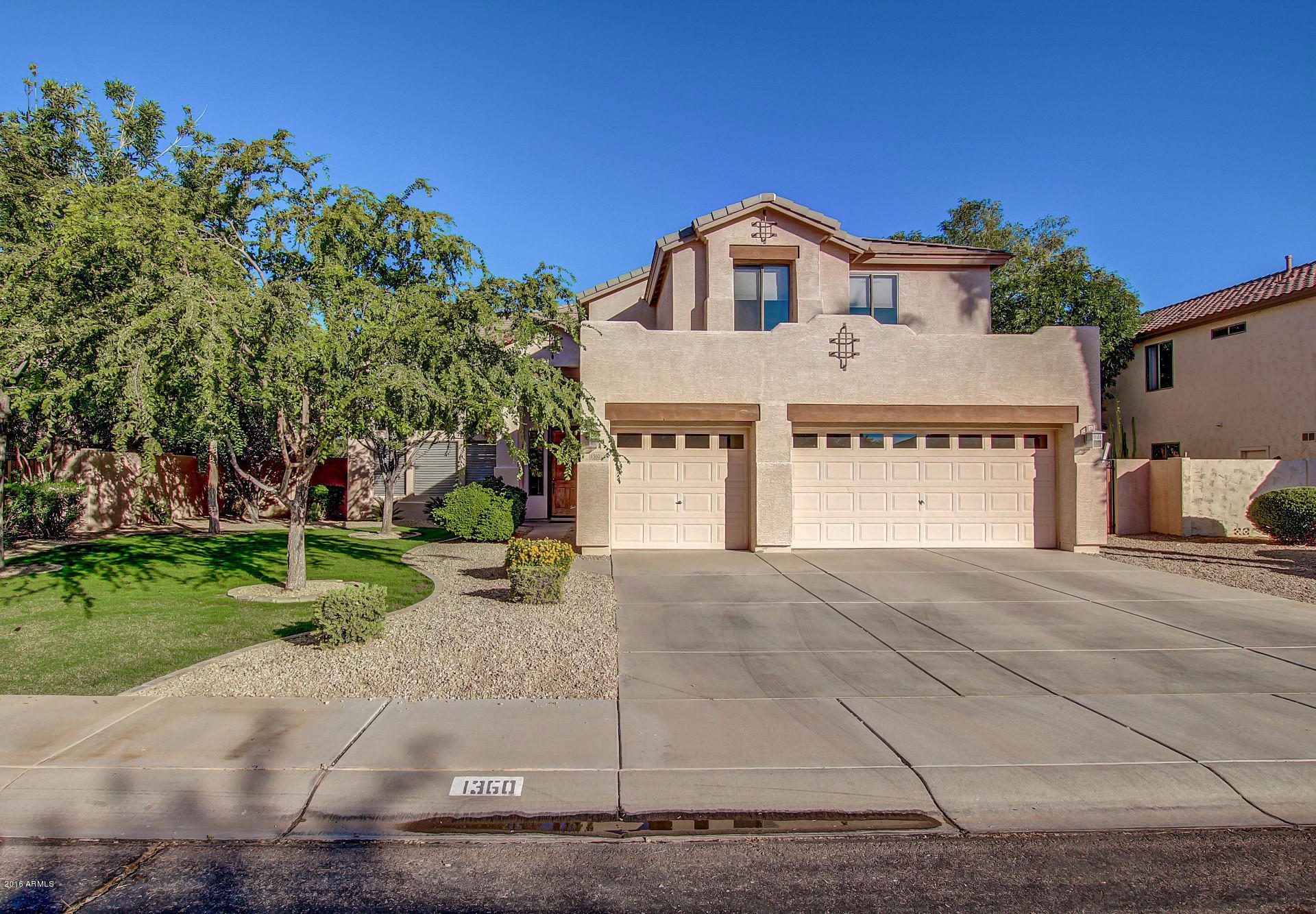 1360 East Harrison Street Gilbert, AZ 85295 - Photo 3 of 34 a front view of a house with a yard and garage