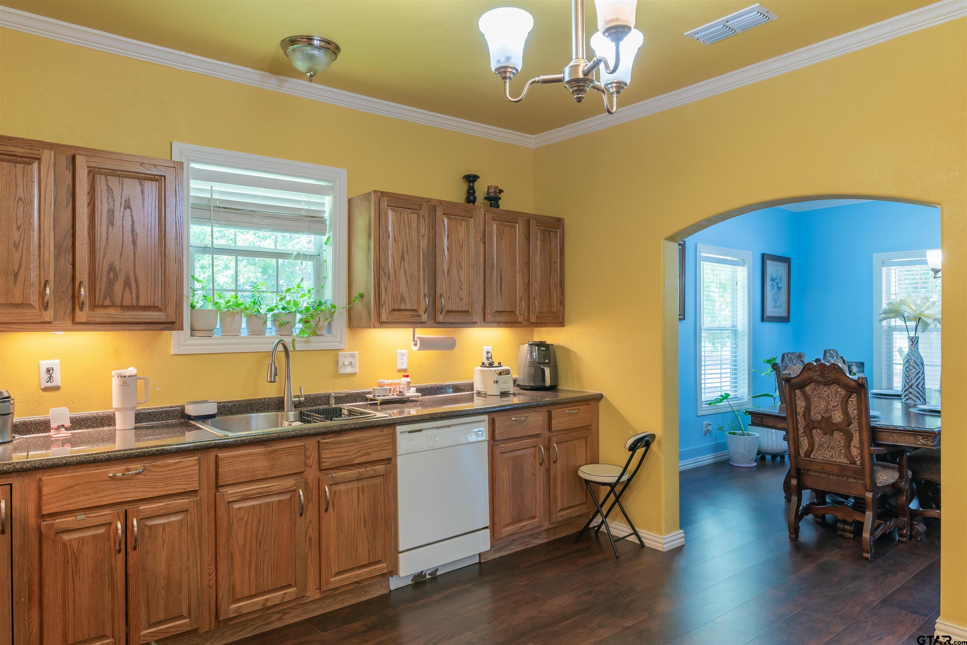 427 East Locust Street Tyler, TX 75702 - Photo 13 of 42 a kitchen with sink cabinets and wooden floor
