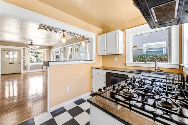 a kitchen with a stove a sink and a microwave