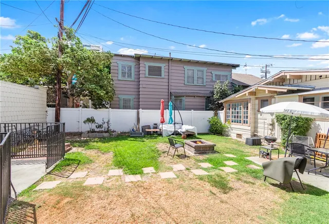 a view of backyard with a table and chairs and potted plants