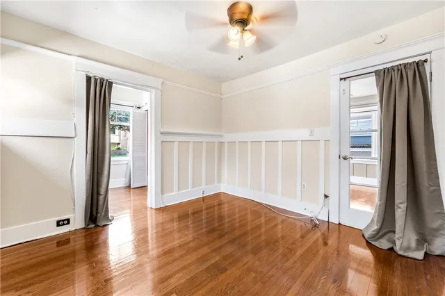 wooden floor in an empty room with a window