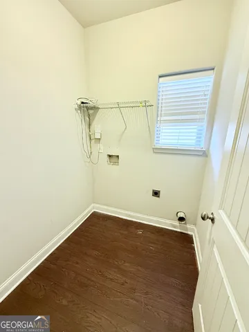 a view of a room with wooden floor and a ceiling fan