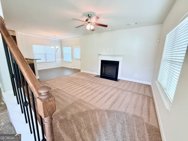 a spacious bedroom with a bed and a ceiling fan