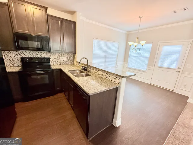 a kitchen with a sink stove and microwave