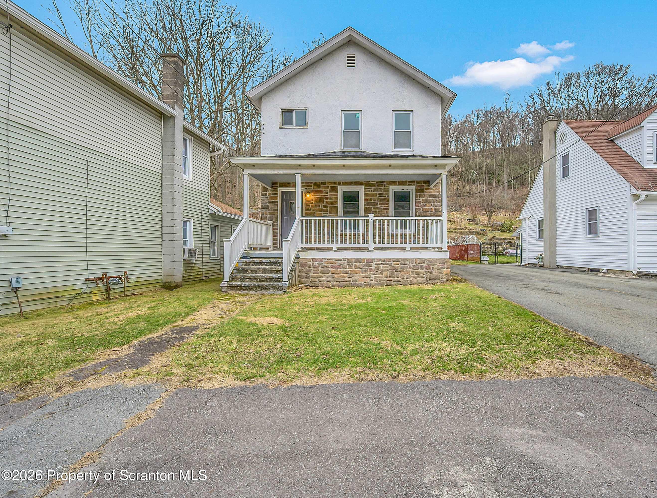 602 Main Street Archbald, PA 18403 - Photo 2 of 26 a front view of a house with a yard
