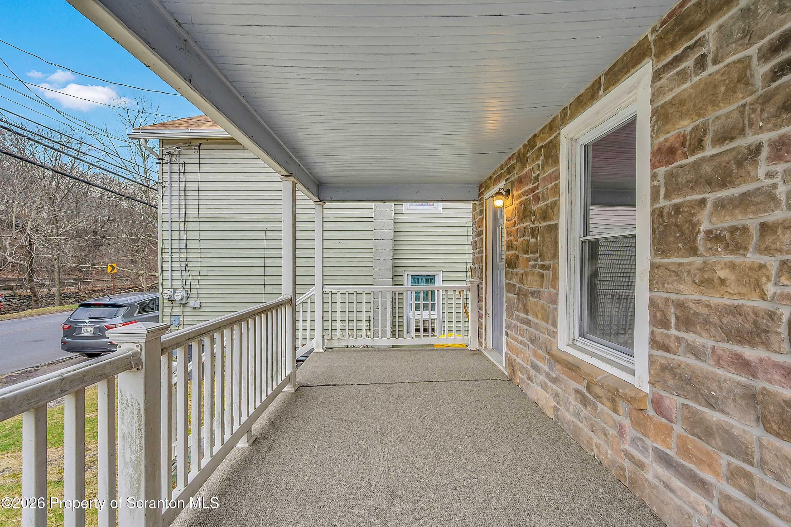 602 Main Street Archbald, PA 18403 - Photo 3 of 26 a view of a porch with wooden floor and fence