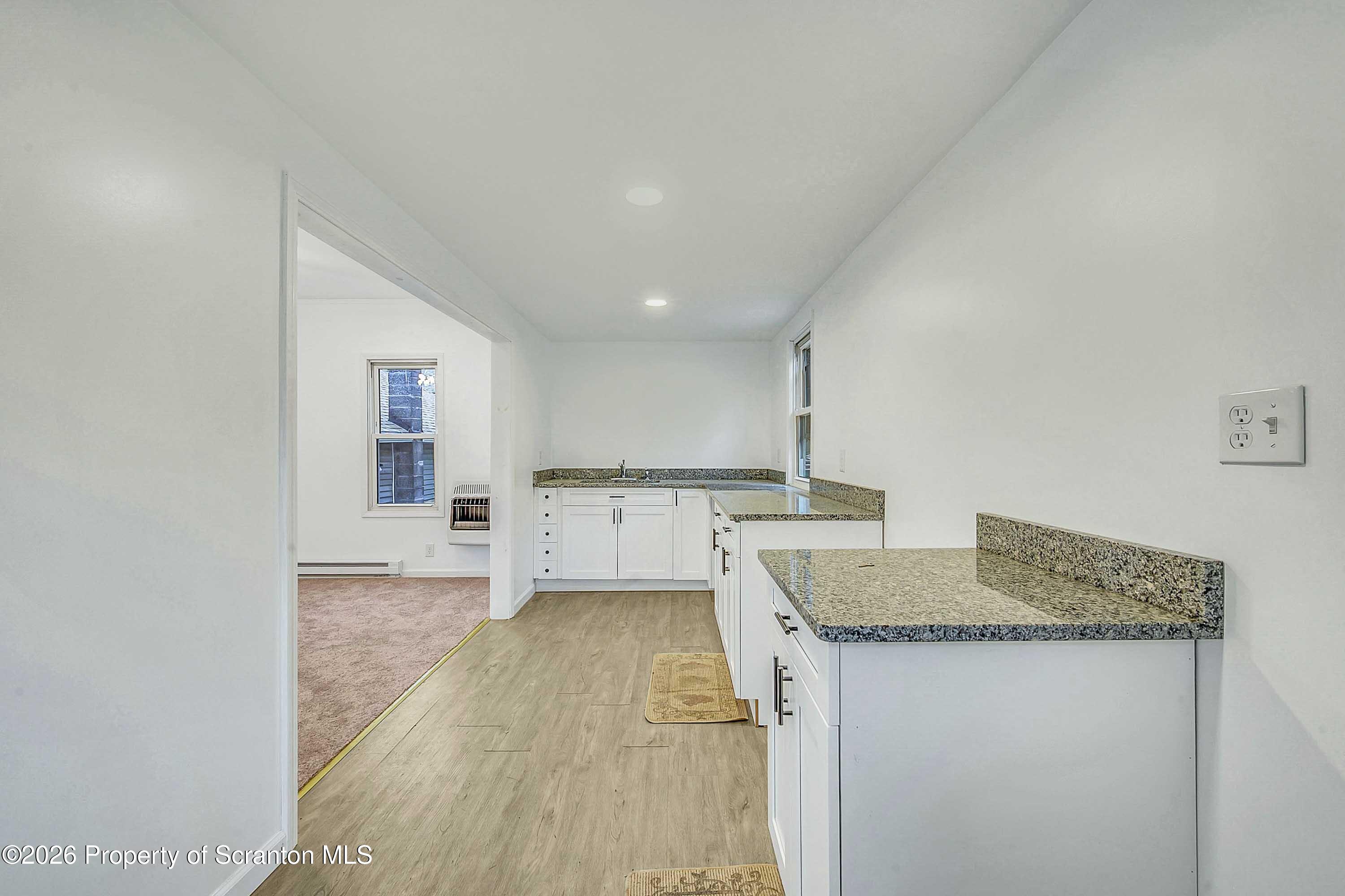 602 Main Street Archbald, PA 18403 - Photo 9 of 26 a kitchen with granite countertop a sink stove and cabinets