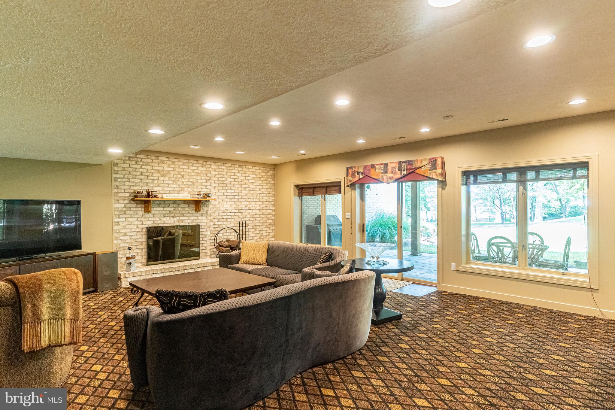 9129 Persimmon Tree Road Potomac, MD 20854 - Photo 37 of 51 Walkout Lower Level Recreation Room w/ Fireplace