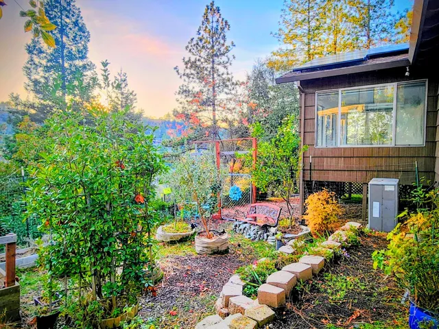 a view of a hallway with wooden floor and a bathroom