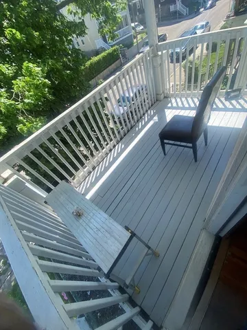 a view of a balcony with wooden floor